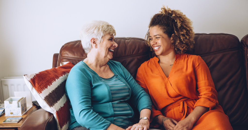 Senior woman and caregiver laughing